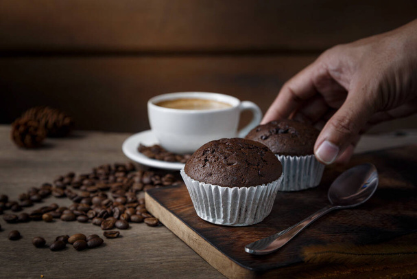 Chocolate cupcakes with a cup of coffee served in the morning. - 写真・画像