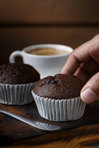 Chocolate cupcakes with a cup of coffee served in the morning. - Photo, Image