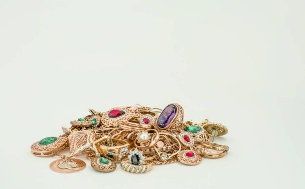 Pile of gold jewelry on white background - Foto, afbeelding