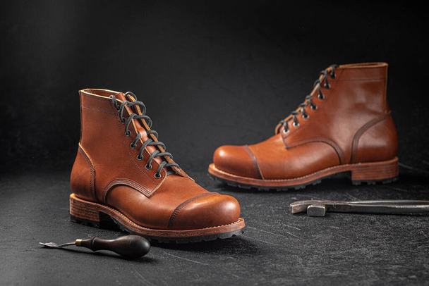 Handcrafted brown leather shoes with cobbler tools - Foto, immagini
