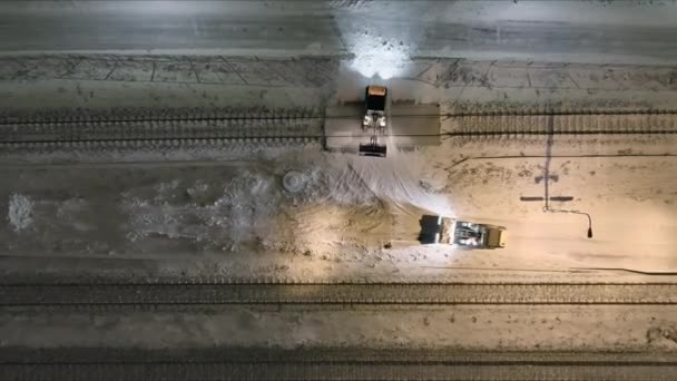 Small tractors clearing snow off of the train tracks in Vantaa. - Séquence, vidéo