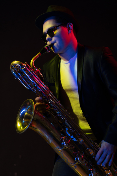 Japanese Musician Saxophonist Holds a Soprano Straight Saxophone in his Hand and Poses for Camera on a Black Background. Close-up Portrait  - Fotoğraf, Görsel