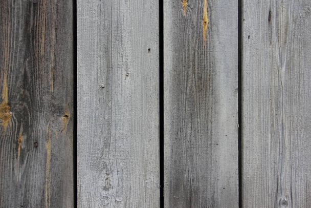 Old dry gray wooden wall surface of a rural barn with weathered vertical boards close-up - vintage rustic background texture - Φωτογραφία, εικόνα