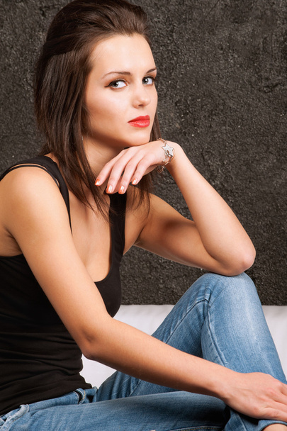 Young woman sitting on a sofa - Фото, зображення