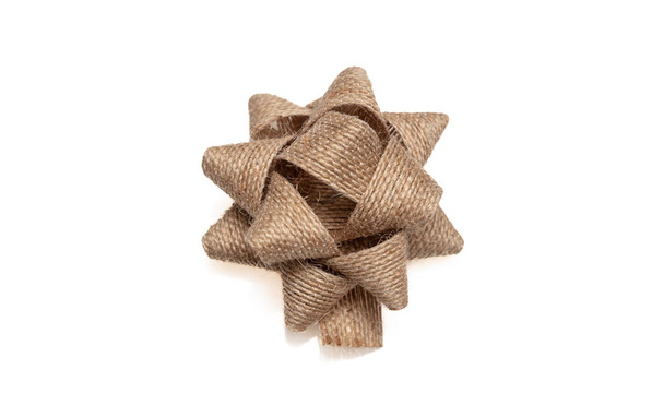 Burlap jute gift bow isolated cutout on white background, design element, Present wrapping decoration - Фото, изображение