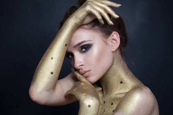 Sensual fashion model woman with gold skin and makeup portrait - Fotoğraf, Görsel