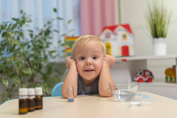 little boy child blonde play chemical experiments to sit at the table at home - Zdjęcie, obraz