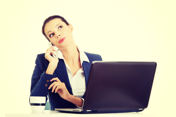 Smiling young business woman speaking on phone - Photo, Image