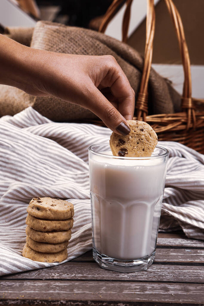 Dipping delicious cookies in a glass of milk - Photo, Image