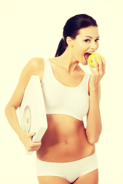 Attractive fit woman with scale and apple - Фото, зображення