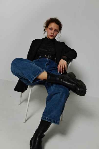 pretty woman sitting on a chair in a black jacket fashion posing Lifestyle unaltered - Fotó, kép