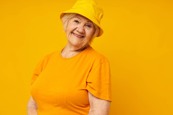 smiling elderly woman happy lifestyle in a yellow headdress close-up emotions - Fotó, kép