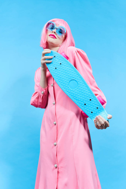 fashionable woman fashion blue glasses skateboard studio model unaltered - Fotó, kép