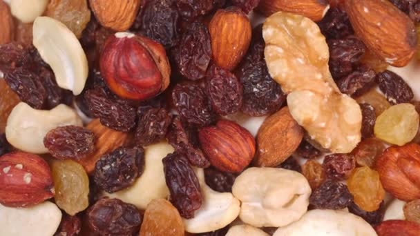 spinning nuts. close-up of nut mixture slow motion - Felvétel, videó