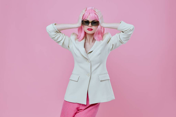 Positive young woman wearing sunglasses pink hair posing color background unaltered - Foto, Imagem