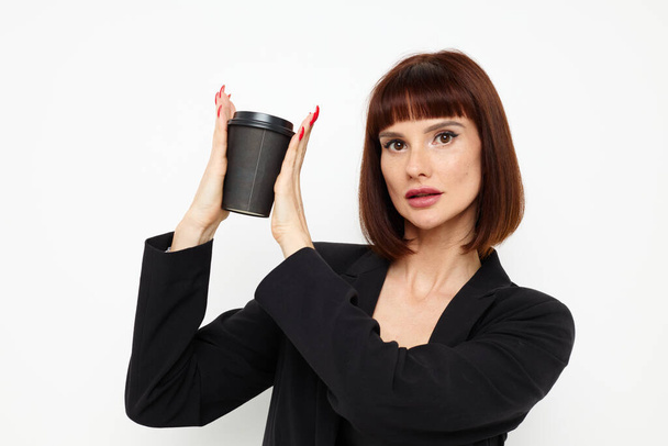photo pretty woman black jacket drink glass posing isolated background - Foto, immagini