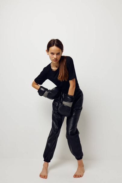 young woman in black sports uniform boxing gloves posing Lifestyle unaltered - Photo, image