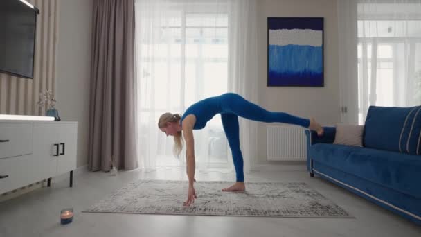 sporty skinny girl bends her back doing , Stock Video