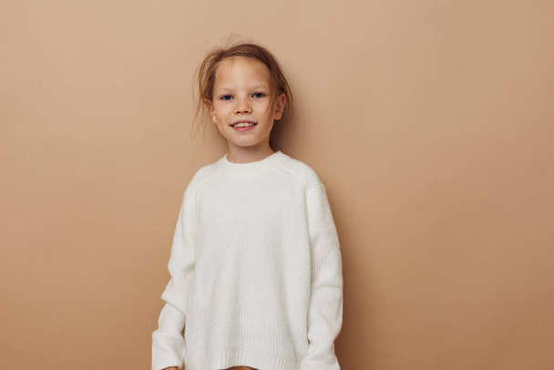 cute girl in white sweater posing hand gestures isolated background - Valokuva, kuva