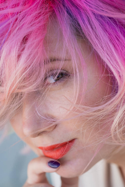 Close-up portrait of curly Caucasian woman with multi-colored hair. Model for hairstyles - 写真・画像