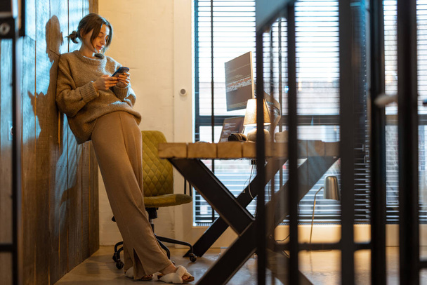 Woman works from cozy home office - 写真・画像