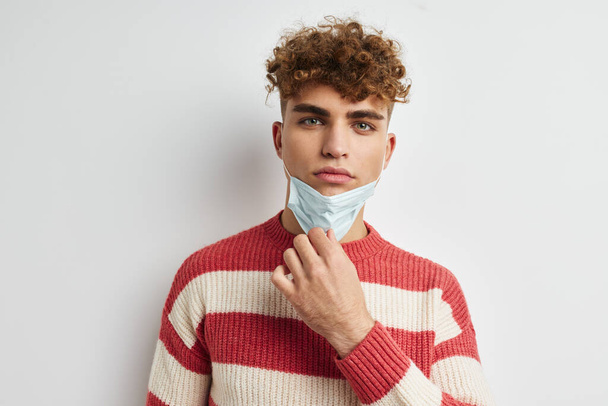 kinky guy in sweater medical mask safety - Valokuva, kuva