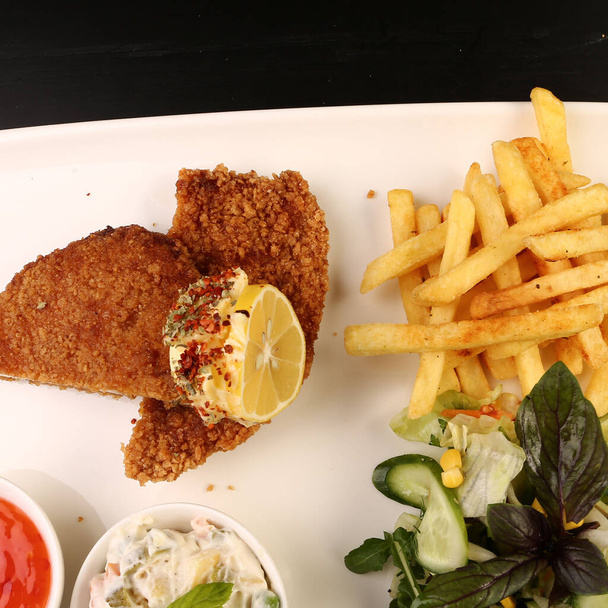 Delicious schnitzel served with french fries - Foto, Imagen