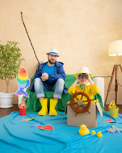 Happy family playing. Dad and son enjoying a fishing trip. Father and child having fun. Man and kid at home. Summer vacation and Fathers day concept - Photo, Image