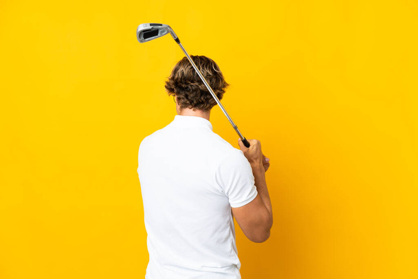 English man over isolated white background playing golf - Foto, afbeelding