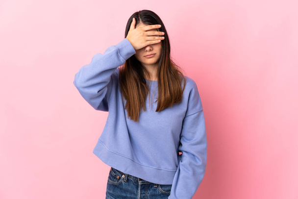 Young caucasian woman isolated on pink background covering eyes by hands. Do not want to see something - Φωτογραφία, εικόνα