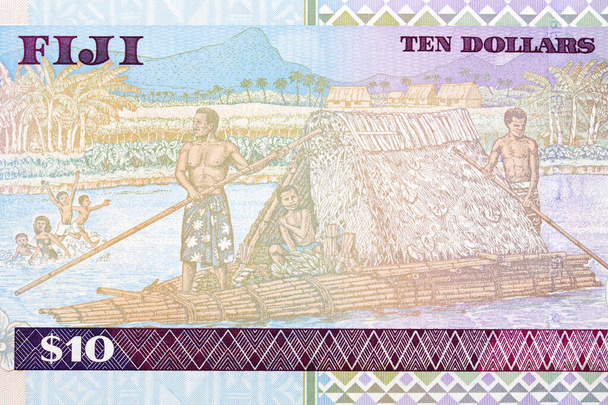 Family in boat constructed of reeds with thatched roof shelter from Fijian money - Фото, изображение