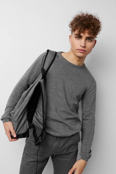 handsome guy in a gray sweater backpack fashion isolated background - Fotoğraf, Görsel