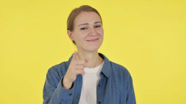 Young Woman Pointing at the Camera on Yellow Background - Photo, Image