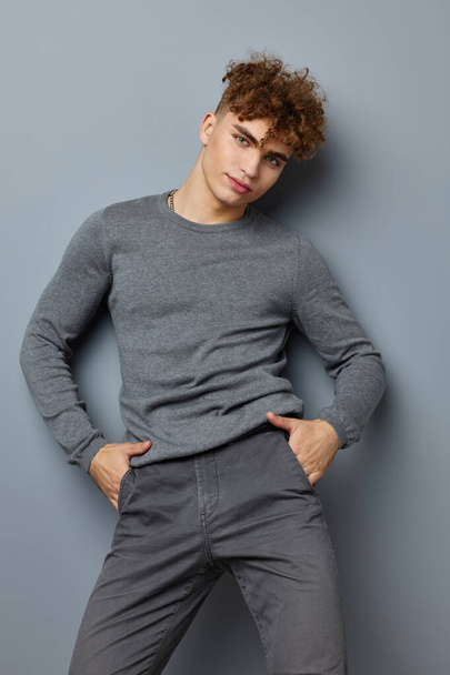 kinky guy in a gray sweatshirt fashion studio Lifestyle unaltered - Zdjęcie, obraz