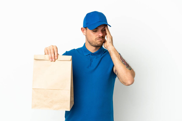 Brazilian taking a bag of takeaway food isolated on white background with headache - Фото, изображение