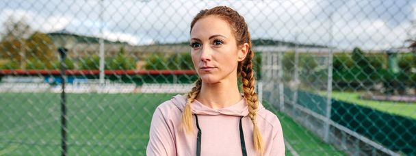 Serious sportswoman with boxer braids posing with crossed arms - Foto, Imagen