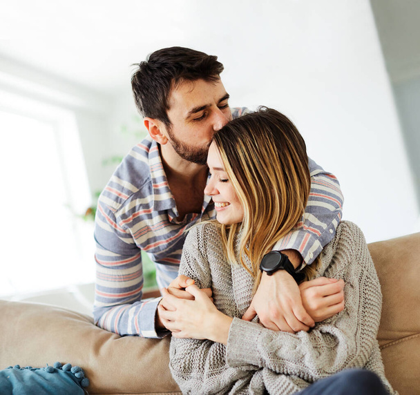 couple love sofa home hug romance happy relationship valentine day - Valokuva, kuva