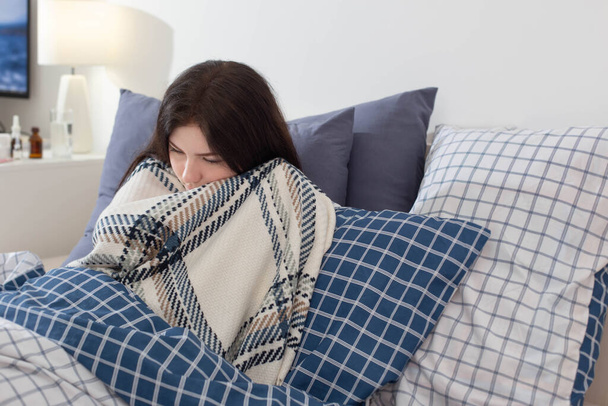 sick girl in  blanket on pillow in bedroom - Foto, Imagen