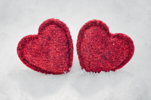 two red hearts on a snow background - Photo, image