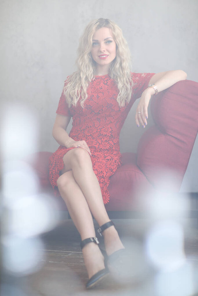 Beautiful blond woman in red dress - Fotó, kép