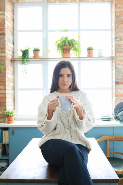 Woman in white sweater at home - Foto, imagen
