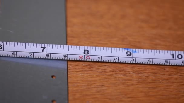 construction tape measure with a scale, length measurement close-up - Felvétel, videó