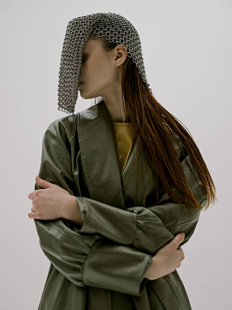attractive woman fashion leather coat glamor chain mail light background - Valokuva, kuva