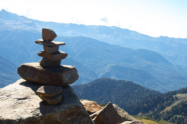Pyramids of stones on the top of mountain. Panorama of the Caucasus mountains - Photo, Image