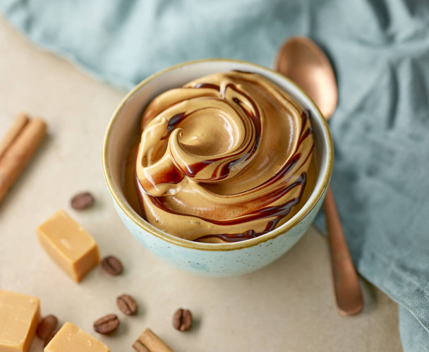 whipped caramel and coffee mousse cream dessert on kitchen table - Φωτογραφία, εικόνα