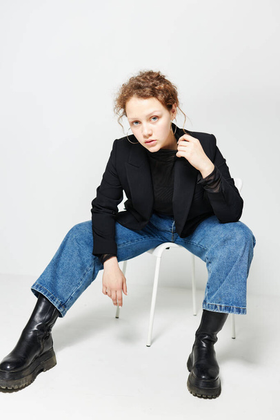 beautiful woman sitting on a chair in a black jacket fashion posing Lifestyle unaltered - Foto, imagen