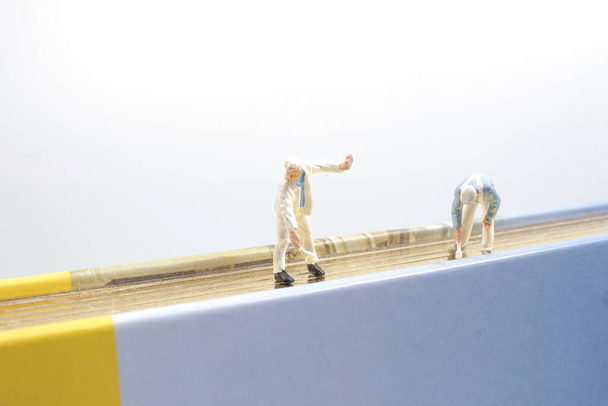 the mini of figure paint on the book - Φωτογραφία, εικόνα