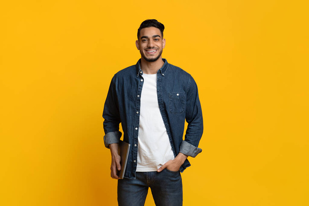 Smiling middle eastern man in casual with laptop - Photo, Image