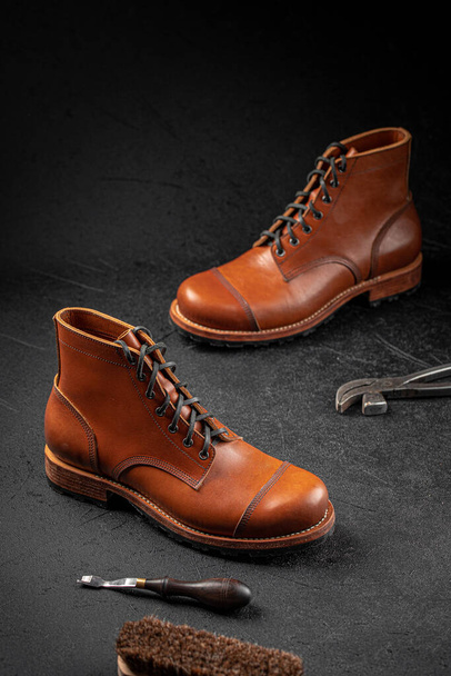Handcrafted brown leather shoes with cobbler tools - Foto, immagini