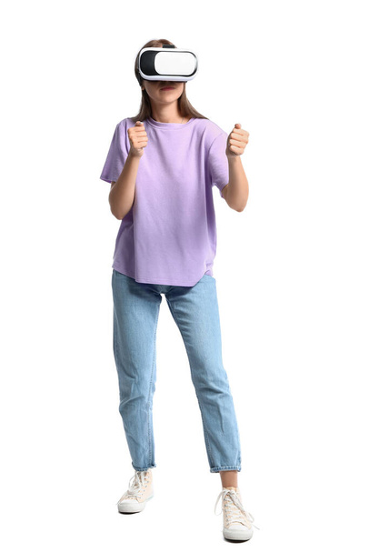 Young woman in lilac t-shirt with VR glasses on white background - Фото, зображення